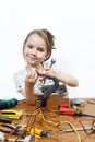 Blonde little girl repair a computer component