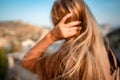 Blonde long hair, nature summer happy adult girl with long blond hair developing in the wind in nature. Dressed in a Royalty Free Stock Photo