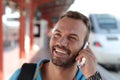 Blonde man calling by phone from train station Royalty Free Stock Photo