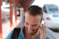 Blonde man calling by phone from train station Royalty Free Stock Photo
