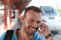 Blonde man calling by phone from train station Royalty Free Stock Photo