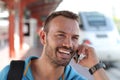 Blonde man calling by phone from train station Royalty Free Stock Photo