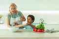 Blonde mature mother with her child son preparing healthy eating Royalty Free Stock Photo