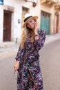 Blonde Mediterranean woman floral pattern dress posing