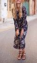 Blonde Mediterranean woman floral pattern dress posing concept