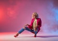 Blonde model posing over pink red background Royalty Free Stock Photo