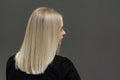 Blonde model with straight hair, look from behind. Hair bleaching result. Copy space Royalty Free Stock Photo