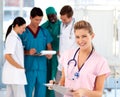 Blonde nurse with her team in the background Royalty Free Stock Photo