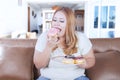 Blonde obesity woman eats donuts Royalty Free Stock Photo