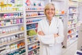 Blonde pharmacist with arms crossed smiling at camera Royalty Free Stock Photo