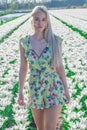 Sexy blonde at a photo shoot in a field of flowers and tulips Holland