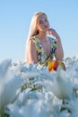 Sexy blonde at a photo shoot in a field of flowers and tulips Holland