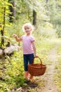 Blonde preschool little girl picking fresh edible mushrooms