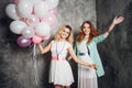 Blonde and redhead. Two young charming girlfriends at the party. Royalty Free Stock Photo