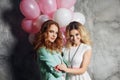 Blonde and redhead. Two young charming girlfriends at the party. Royalty Free Stock Photo