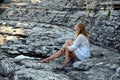 Blonde on rocky beach Royalty Free Stock Photo