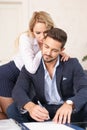 Blonde secretary lover seducing rich boss in office, whispering, mind control Royalty Free Stock Photo