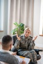 Blonde servicewoman explaining her anxiety to psychologist