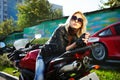 Blonde sits about a red motorcycle Royalty Free Stock Photo