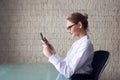 Blonde smart businesswoman working on tablet Royalty Free Stock Photo