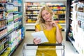 Blonde smiling woman checking list Royalty Free Stock Photo