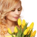 Blonde smiling woman with yellow tulips, isolated Royalty Free Stock Photo