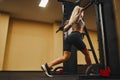 Blonde sport woman working out legs with barbell in gym. personal female trainer. Perfect body Royalty Free Stock Photo