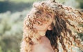 Blonde spring girl with curly beautiful hair smiling. Beauty hair Salon. Fashion haircut. Beauty girl with long and