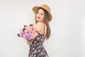 Blonde in a straw hat and dress with a bouquet of flowers Royalty Free Stock Photo