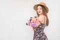 Blonde in a straw hat and dress with a bouquet of flowers Royalty Free Stock Photo