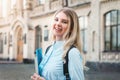 Student girl is smiling and holding a folder and a notebook in her hands on a university background. Girl is taking exams Royalty Free Stock Photo