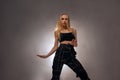 blonde stylish woman dressed in stylish black clothes is dancing street dance. Royalty Free Stock Photo