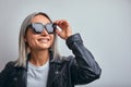 Blonde sunglasses leather jacket on a gray background. copy space Royalty Free Stock Photo