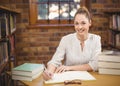 Blonde teacher correcting in the library