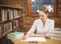 Blonde teacher correcting in the library