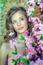 Blonde teen girl near a blossoming tree Royalty Free Stock Photo