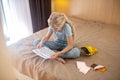 A blonde teen ,marking days of her periods in a calendar