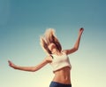 Blonde teenager girl jumping happy with the blue Royalty Free Stock Photo