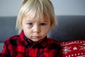 Blonde toddler boy with red burned spot under the eye, feeling pain Royalty Free Stock Photo