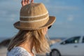 Blonde Tourist Girl with hat in the Parque Natual Dunas de Corralejo on Fuerteventura in Canary Islands in Spain