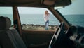 Blonde traveler calling cellphone walking on ocean shore. Woman talking on coast Royalty Free Stock Photo
