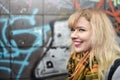 Blonde urban teen girl against grafitti wall Royalty Free Stock Photo