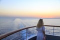 Blonde watching sunset from cruise ship Royalty Free Stock Photo