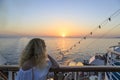 Blonde watching sunset from cruise ship Royalty Free Stock Photo