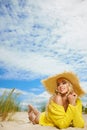 Blonde wearing sun hat at the beach
