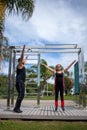 Blonde lady exercising with her personal trainer