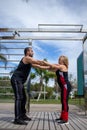 Blonde lady exercising with her personal trainer