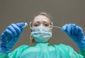 A blonde white woman laboratory technician performs a control swab for possible Covid-19 coronavirus infection Royalty Free Stock Photo