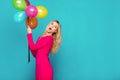 Blonde woman with balloons on blue Royalty Free Stock Photo