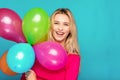 Blonde woman with balloons on blue Royalty Free Stock Photo